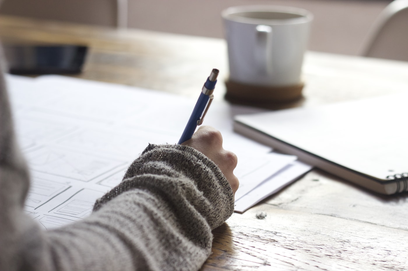 A student writing notes while preparing